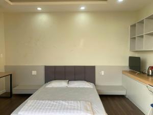 a bedroom with a large bed in a room at Love's Hotel in Nhơn Trạch