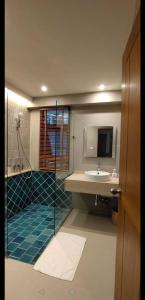 a bathroom with a sink and a shower with a mirror at Villa Baan Loukpla in Hua Hin +11 photos