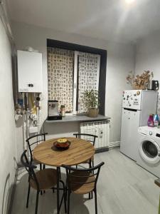 a kitchen with a table and chairs and a refrigerator at Studio in the center in Craiova