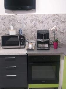 a kitchen with a microwave and a coffee maker on a counter at Studio in the center in Craiova +2 photos