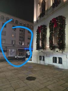 a building with christmas decorations on the side of it at Studio in the center in Craiova