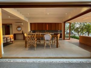 a dining room and kitchen with a table and chairs at Villa Baan Loukpla in Hua Hin