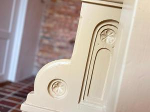 a white door with a design on it at Tiny flat - in medieval Ystad in Ystad
