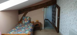 a bedroom with a bed and a stair case at GITE les 3 COQUELICOTS in Coublanc