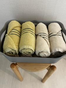 a bunch of folded towels in a pan on a table at Hill-house in Samgong
