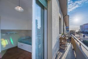 a balcony with a bed and a view of the city at Lido del Bardo in Marina di Cecina