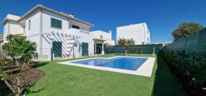 a white house with a swimming pool in a yard at Villa Pretty Stunning House with Garden and Private Swimming Pool in Almancil