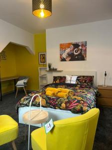 a room with a bed and a table and chairs at 2 Newcastle Street in Crewe