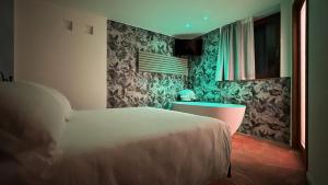 a bedroom with a white bed and a window at Corte d'Arnosto - Casa Virginia in Fuipiano Valle Imagna