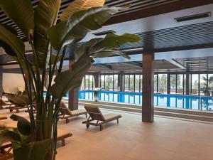 a large plant in a vase next to a pool at Luxury Suites White Sails in Batumi