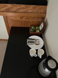 a table with a plate and two cups on it at aba ZARA in Hamburg +13 photos