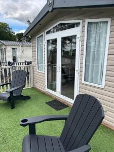 two chairs sitting on a lawn in front of a house at 26 Golf View in Jedburgh