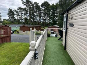 a white fence on the side of a house at 26 Golf View in Jedburgh +36 photos