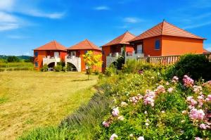 a row of houses in a field with flowers at T3 Piscine Classé 3, Park, Terrasse in Prayssac