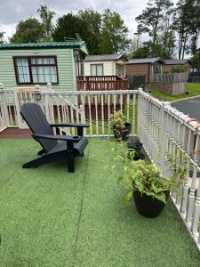 a yard with a bench and a fence at 26 Golf View in Jedburgh