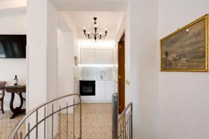 a stairway leading to a kitchen with a painting on the wall at GARDEN VILLA SUITE - Hotel Villa Schuler in Taormina