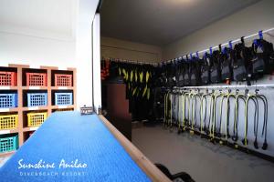 a room with a bunch of skis on a wall at Sunshine Anilao Dive and Beach Resort in Batangas City