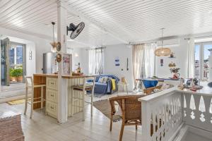 a kitchen and living room with a table and chairs at La Casa Del Limon - Sea Views & Walkable Location in Skopelos Town