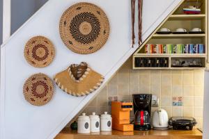 a kitchen with straw hats hanging on a wall at La Casa Del Limon - Sea Views & Walkable Location in Skopelos Town