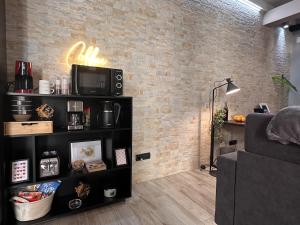a living room with a tv and a couch at The Hangar Loft - Leonoardo, Center & Parking in Sesto Calende