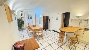 a kitchen with a table and chairs in a room at Garibaldi by LigurianLife in Vallebona