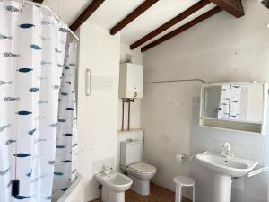 a white bathroom with a toilet and a sink at Garibaldi by LigurianLife in Vallebona +46 photos