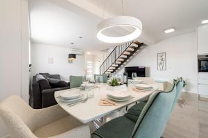 a dining room and living room with a table and chairs at Villa Mare e Monti in Nin