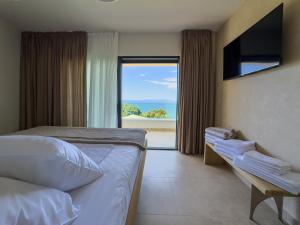 a bedroom with a bed and a view of the ocean at Villa Kukurina - luxury service with view in Potocnica +124 photos