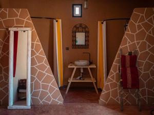 a room with two doors and a table with a sink at Lodge bio berber nomad in Nkob +40 photos