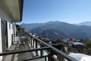 a balcony of a house with a view of mountains at Water Swing B&B in Ren'ai +38 photos
