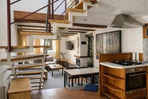 a kitchen and living room with a spiral staircase at Aqualand Penzion - free parking in Poprad