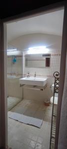a bathroom with a sink and a tub and a toilet at MAS Estrela Chambre Lo Roc in Bessèges
