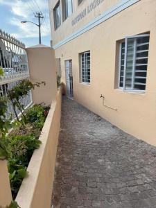 a walkway leading to the entrance to a building at Outspan Lodge in Fish Hoek