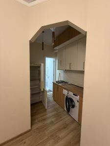 an empty kitchen with a sink and a stove at welcome apartment in Itʼkhvisi