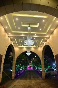 a hallway with a chandelier hanging from a ceiling at Paradise Resort Paonta in Pāonta Sāhib