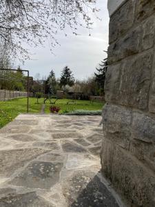 a stone wall with a walkway in a park at FeWo Pelkmann Apartment 2 - Die Grüne Oase - Garten & Balkon in Weikersheim