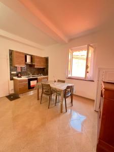 a kitchen with a table and chairs in a room at Kali' in Rapallo