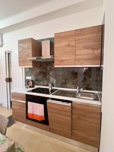 a kitchen with wooden cabinets and a sink at Kali' in Rapallo