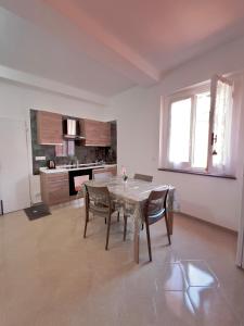 a kitchen and dining room with a table and chairs at Kali' in Rapallo