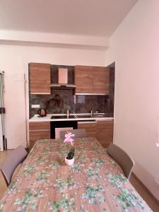 a kitchen with a table with a vase on it at Kali' in Rapallo