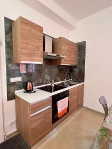 a kitchen with a sink and a stove top oven at Kali' in Rapallo +13 photos