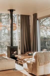a living room with a fireplace and a couch at L'orée du bois aux portes de Montauban in Albias +54 photos