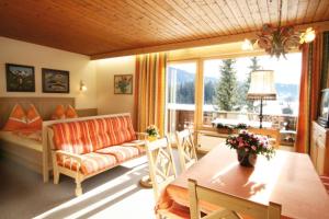 a living room with a couch and a table at Chalet Cristall Superior Appartement 6 in Leutasch