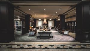 a hotel lobby with a table and chairs at Lord Elgin Hotel in Ottawa