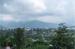 a view of a city with trees and buildings at Cherrywood at Rajpur Road by Zenvana in Dehradun