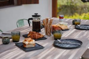 a table with plates of food and drinks on it at Dia View Retreat in Elaía