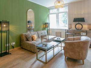 a living room with a couch and a table at Schlosshotel & Himmelreich Braunfels in Braunfels