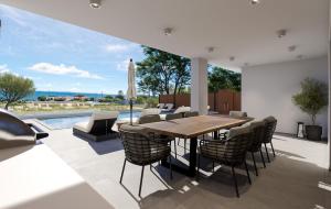 a dining room with a table and chairs and a pool at Villa Morena in Kypseli