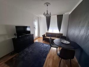 a living room with a table and a couch at Eleon in Novi Sad