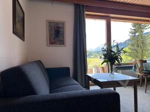 a living room with a couch and a table and a window at Chalet Cristall Superior Appartement 7 in Leutasch
